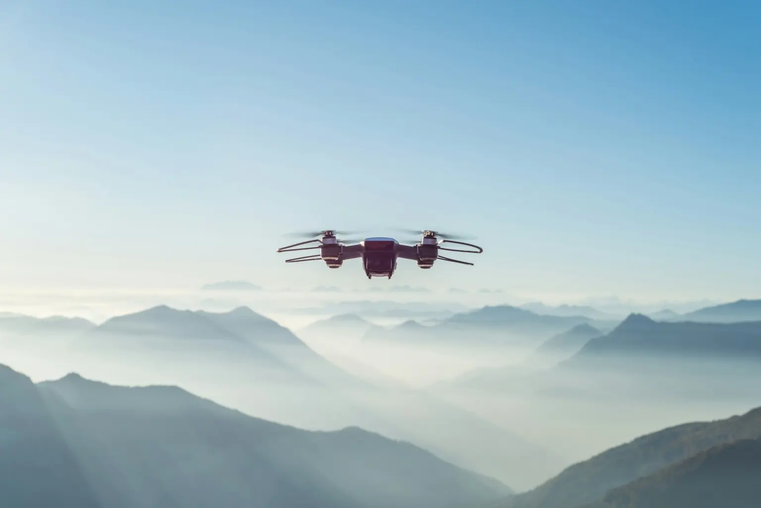 Drone flying over misty mountains