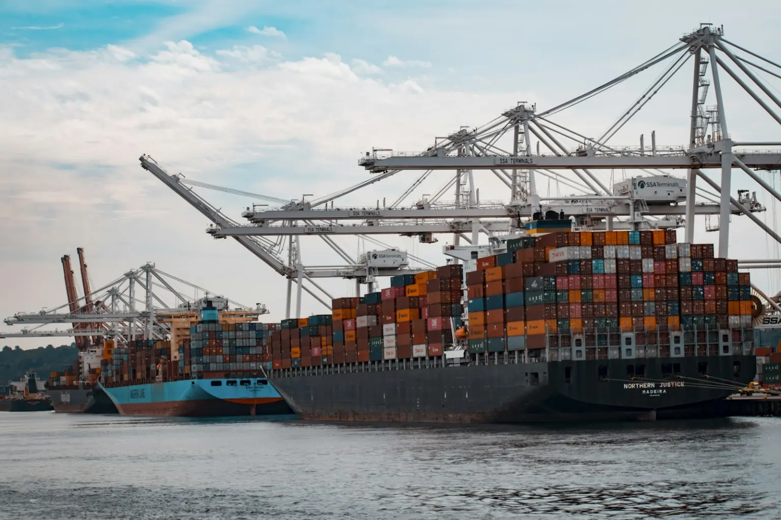 Container ship being loaded by port cranes
